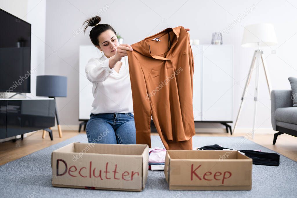 Woman Decluttering Clothes, Sorting And Cleaning Up