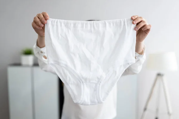 Close Woman Holding White Underwear Stock Photo by ©AndreyPopov 566079958