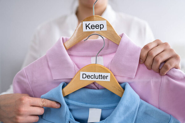 Woman Decluttering Clothes, Sorting And Cleaning Up