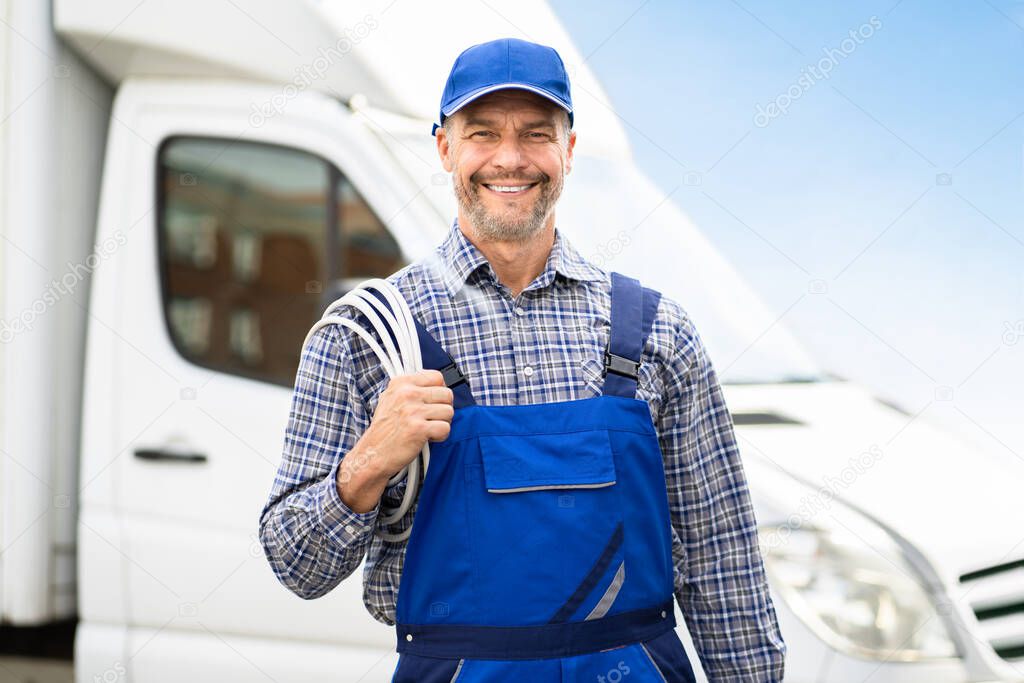 Technician Electrician Man With Cable Near Van