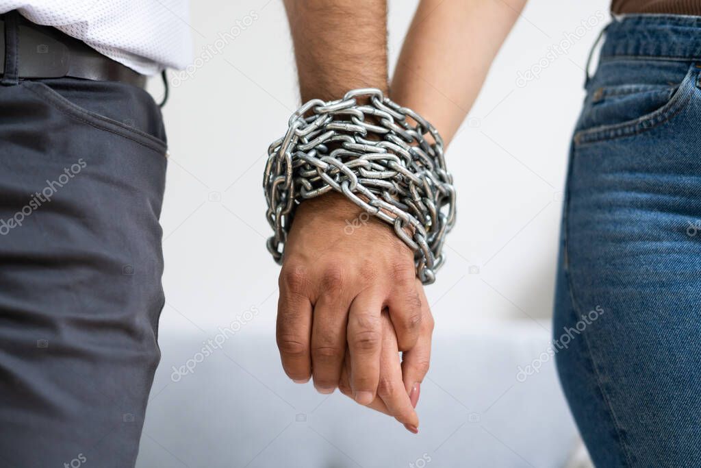 Codependent Relationship Couple. Hand Tied By Chain