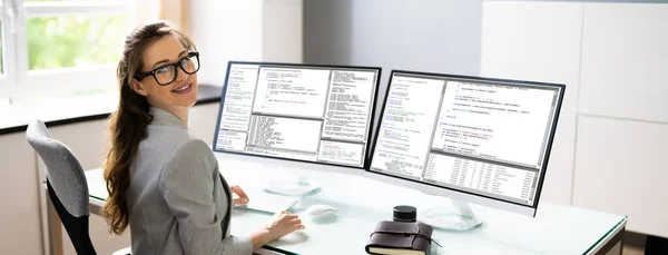 Programmer Woman Coding On Multiple Computer Screens