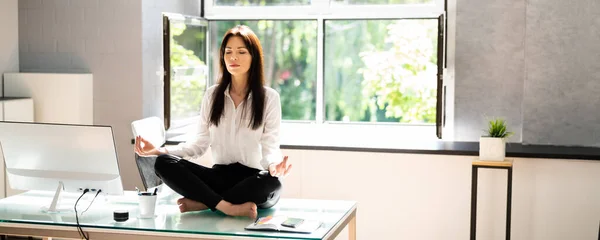 Junge Geschäftsfrau Sitzt Auf Schreibtisch Und Macht Yoga Büro — Stockfoto