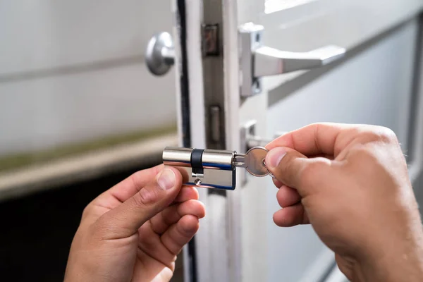 Locksmith Lock Door Repair. Worker Changing And Cylinder