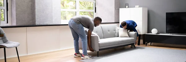 Couple Moving Furniture Living Room Carrying Sofa — Stock Photo, Image