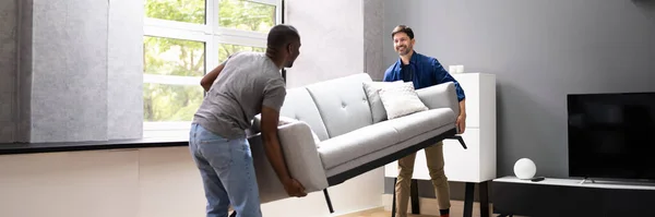 Couple Moving Furniture Living Room Carrying Sofa — Stock Photo, Image