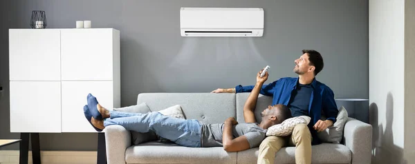 Gay Couple Holding Air Conditioner Remote Happy African American — Stock Photo, Image