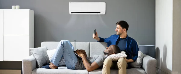 Gay Couple Holding Air Conditioner Remote Glad Afroamerikan — Stockfoto