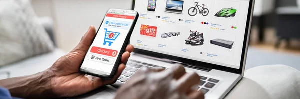 African American Using Online Ecommerce Store Laptop Phone — стокове фото