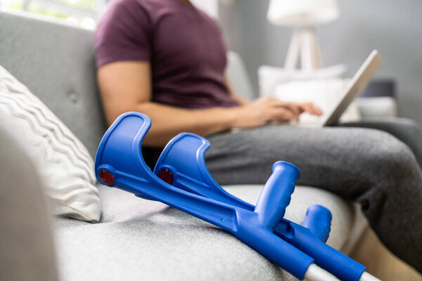 Раненый в ногу человек с костылями после аварии