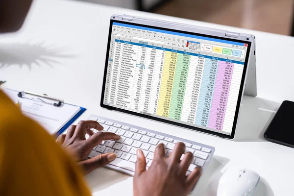 Woman Working With Electronic Spreadsheet Reports On Screen