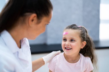 Çocuk yaralarına yara bandı yapıştırıyorum. Çocuk Bandajı