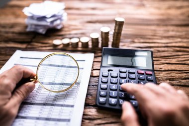Denetçi el Büyüteç çim kullanarak faturasını kontrol. Vergi sahtekarlık soruşturma kavramı