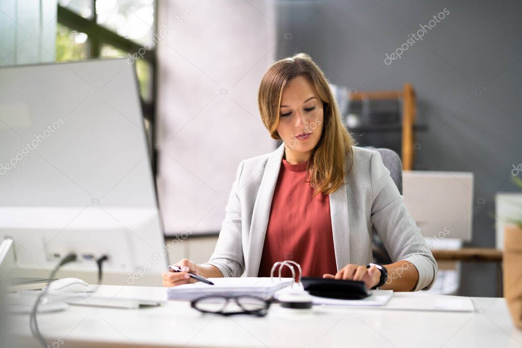 Accountant Women At Desk Using Calculator For Accounting