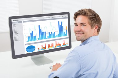 Businessman Analyzing Financial Graphs clipart