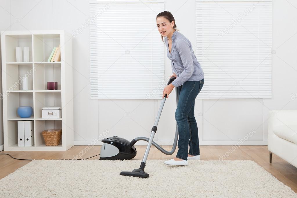 Woman Vacuuming Carpet