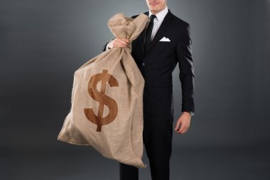 dolar işareti olan torba taşıyan işadamı