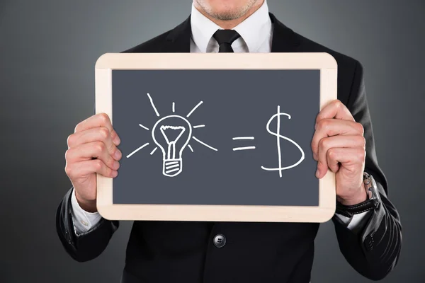 Businessman Holding Slate With Idea Equation — Stock Photo, Image
