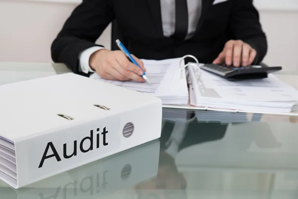 Businessman Calculating Taxes At Desk — Stock Photo, Image