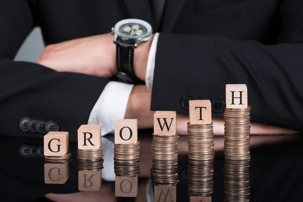 Businessman With Growth Blocks On Stacked Coins — Stock Photo, Image