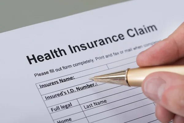 Hand Filling Health Insurance Form — Stock Photo, Image