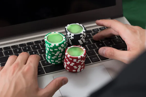 Using Laptop With Stacked Poker Chips — Stock Photo, Image