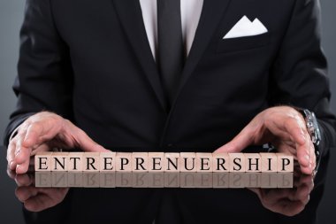 Businessman Showing Entrepreneurship Blocks clipart
