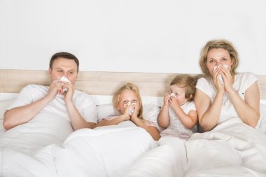 Sick Family Lying In Bed clipart