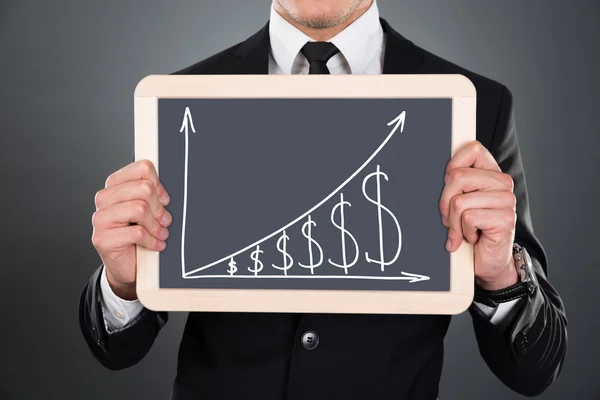 Businessman Holding Slate With Graph And Dollar Signs — Stock Photo, Image