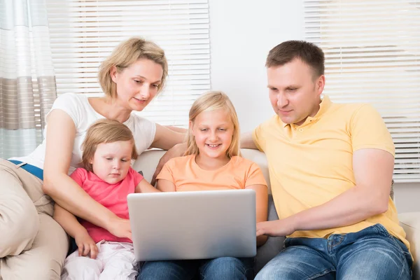 Familie nutzt Laptop auf Sofa — Stockfoto