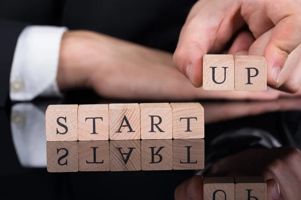 Businessman Arranging Startup Blocks On Desk — Stock Photo, Image