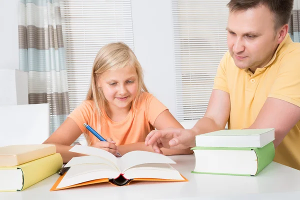 Father Helping Daughter With Homework Royalty Free Stock Images