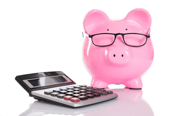 Piggybank e calculadora — Fotografia de Stock