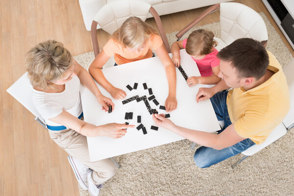 Young Family Playing Domino Game