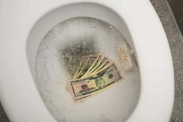 Flushing money down toilet — Stock Photo, Image