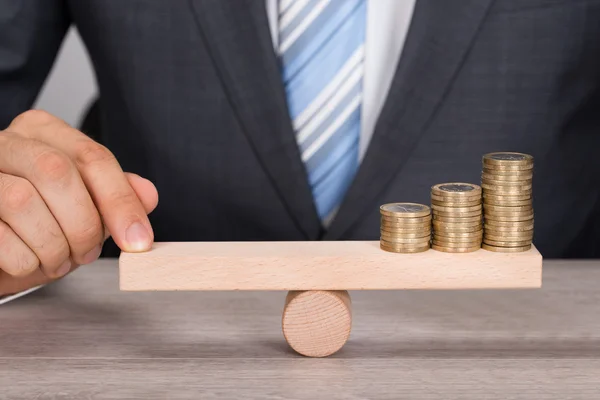 Businessman Balancing Coins — Stock Photo, Image