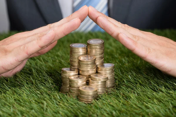 Businessman Shielding  Coins — Stock Photo, Image