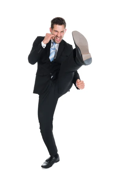 Businessman Kicking Stock Image