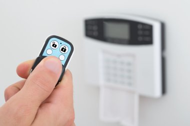 Person Using Security Alarm Control clipart