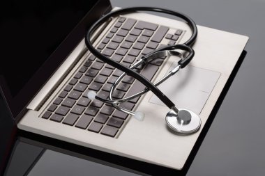 Medical Stethoscope Over Laptop clipart
