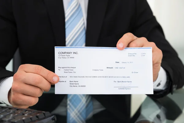 Midsection Of Businessman Showing Cheque — Stock Photo, Image