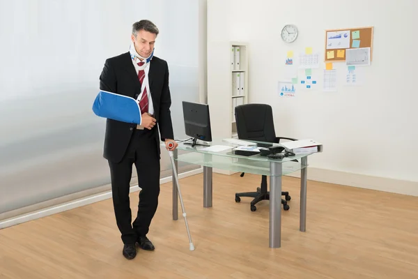 Disabled Businessman Standing With Crutches — Stock Photo, Image