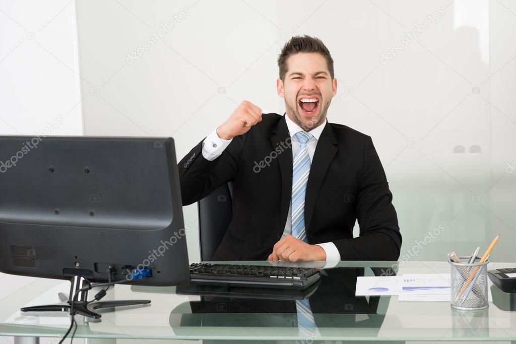 Successful Businessman Screaming At Desk