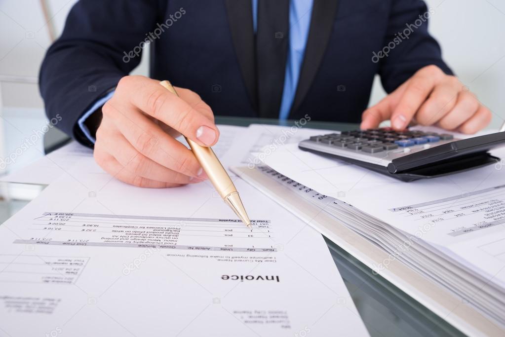 Businessman Calculating Invoices