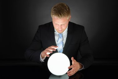 Businessman With Crystal Ball clipart