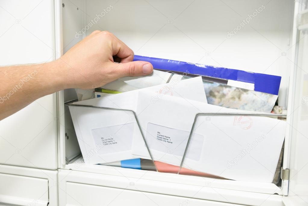 Man Taking Letter From Mailbox