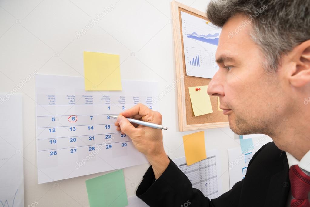 Businessman Highlighting Important Dates