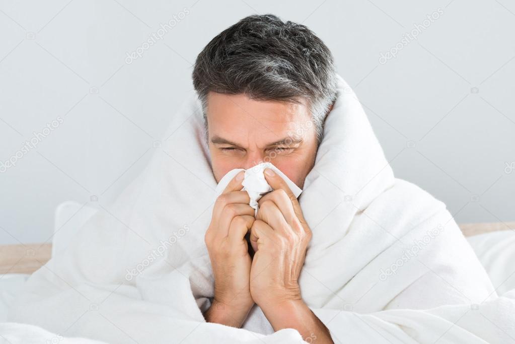 Mature Man Blowing Nose