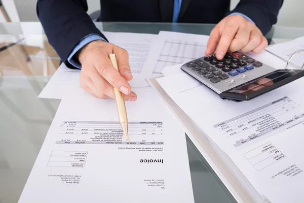 Businessman Calculating Invoices — Stock Photo, Image