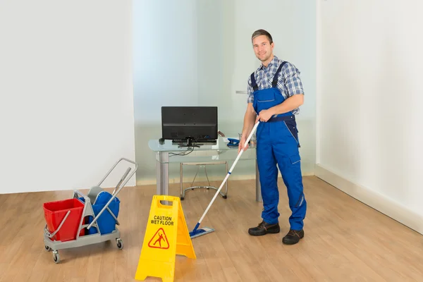 Mann putzt Büroflur — Stockfoto